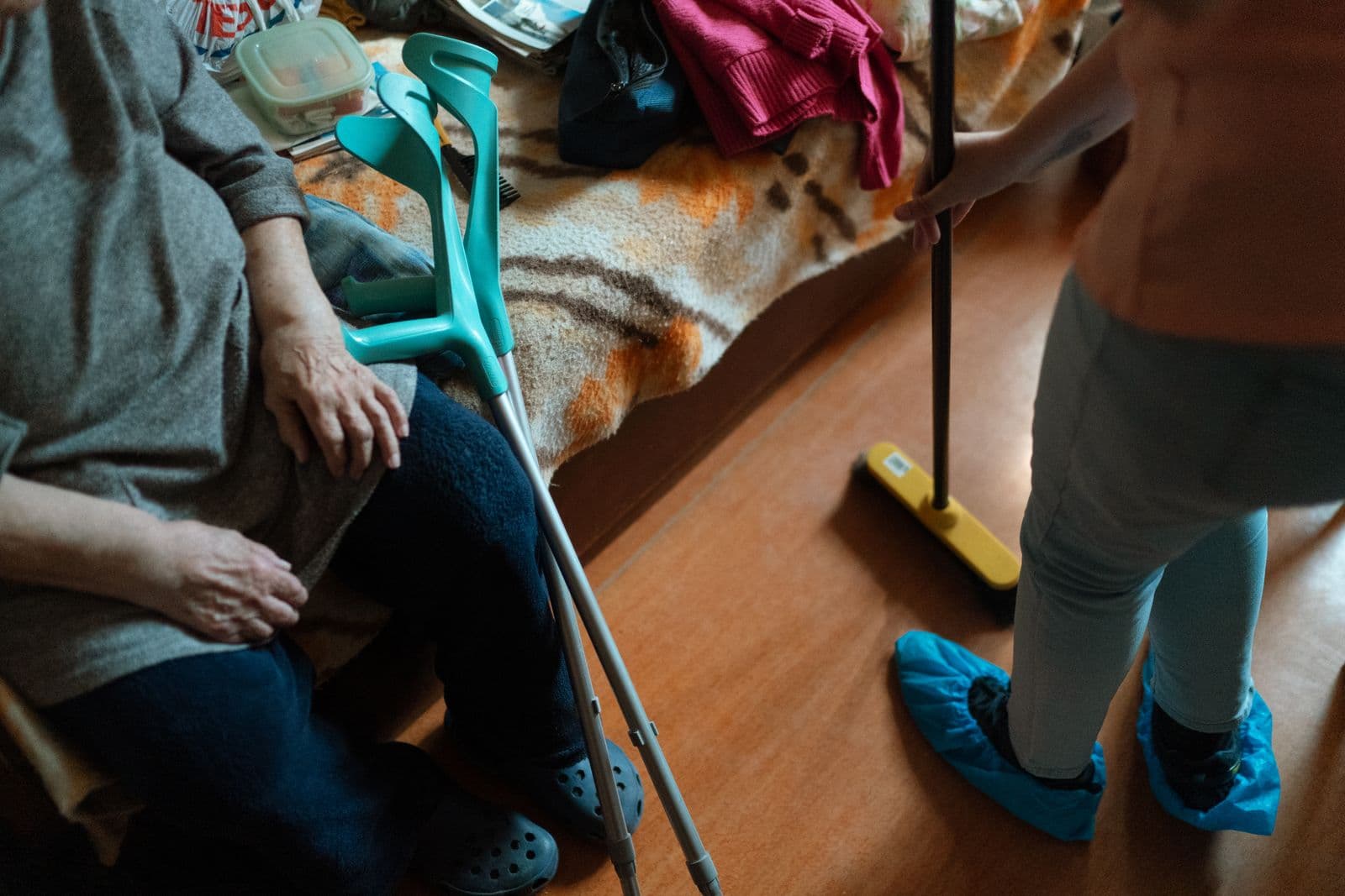 A support worker and an older woman doing housework together
