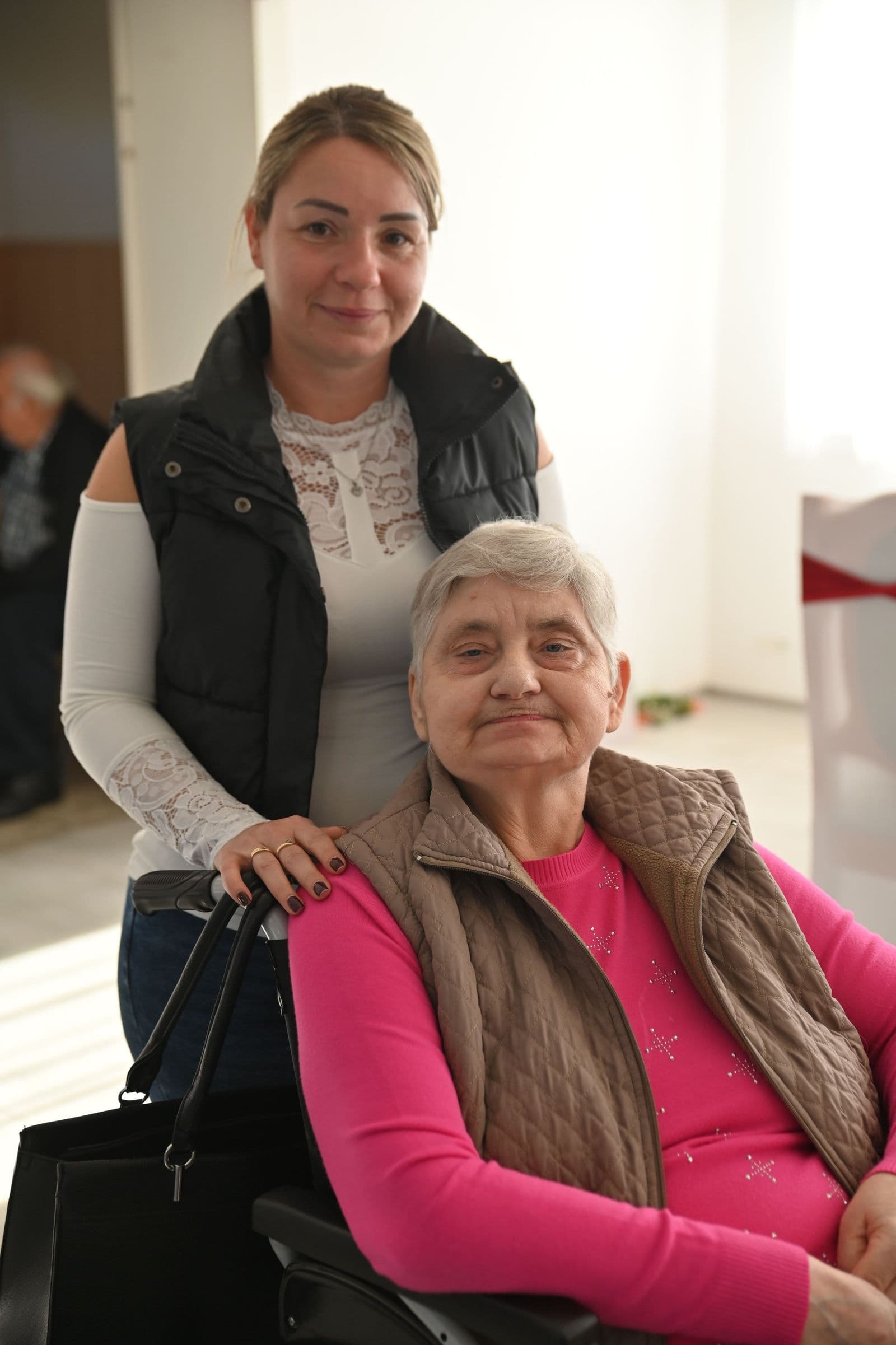 A family member sitting close with an older woman