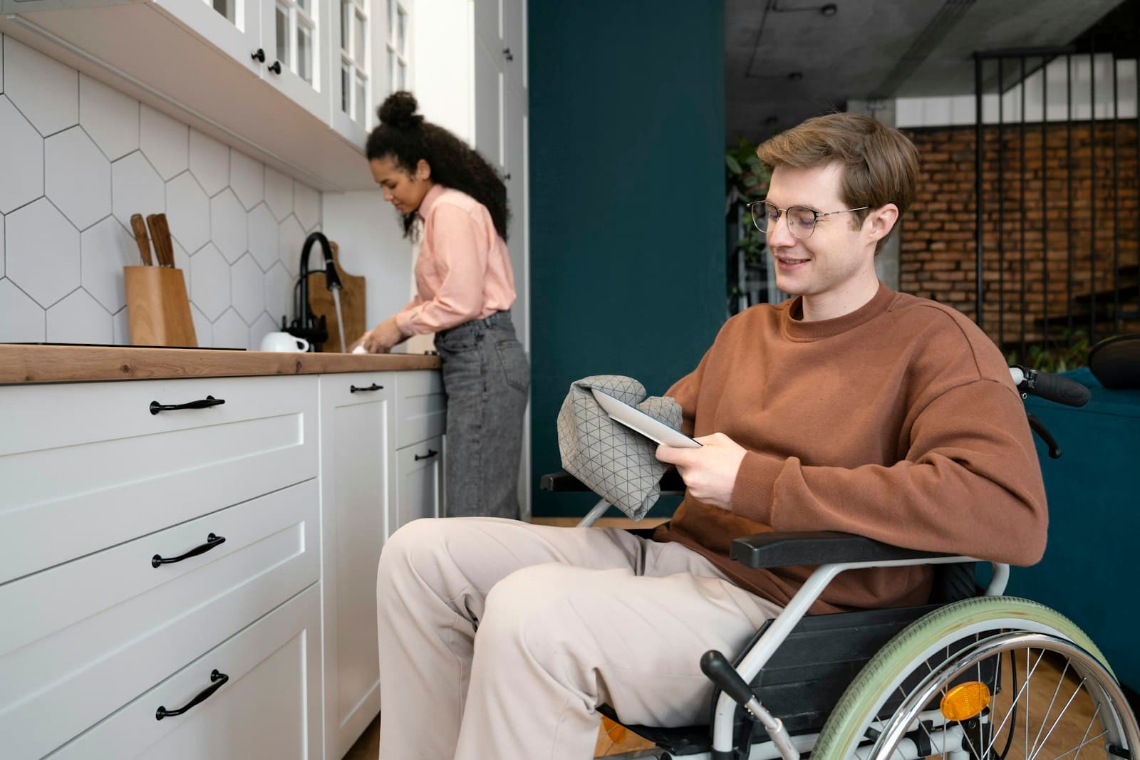 A man using a wheelchair preparing food in his kitchen