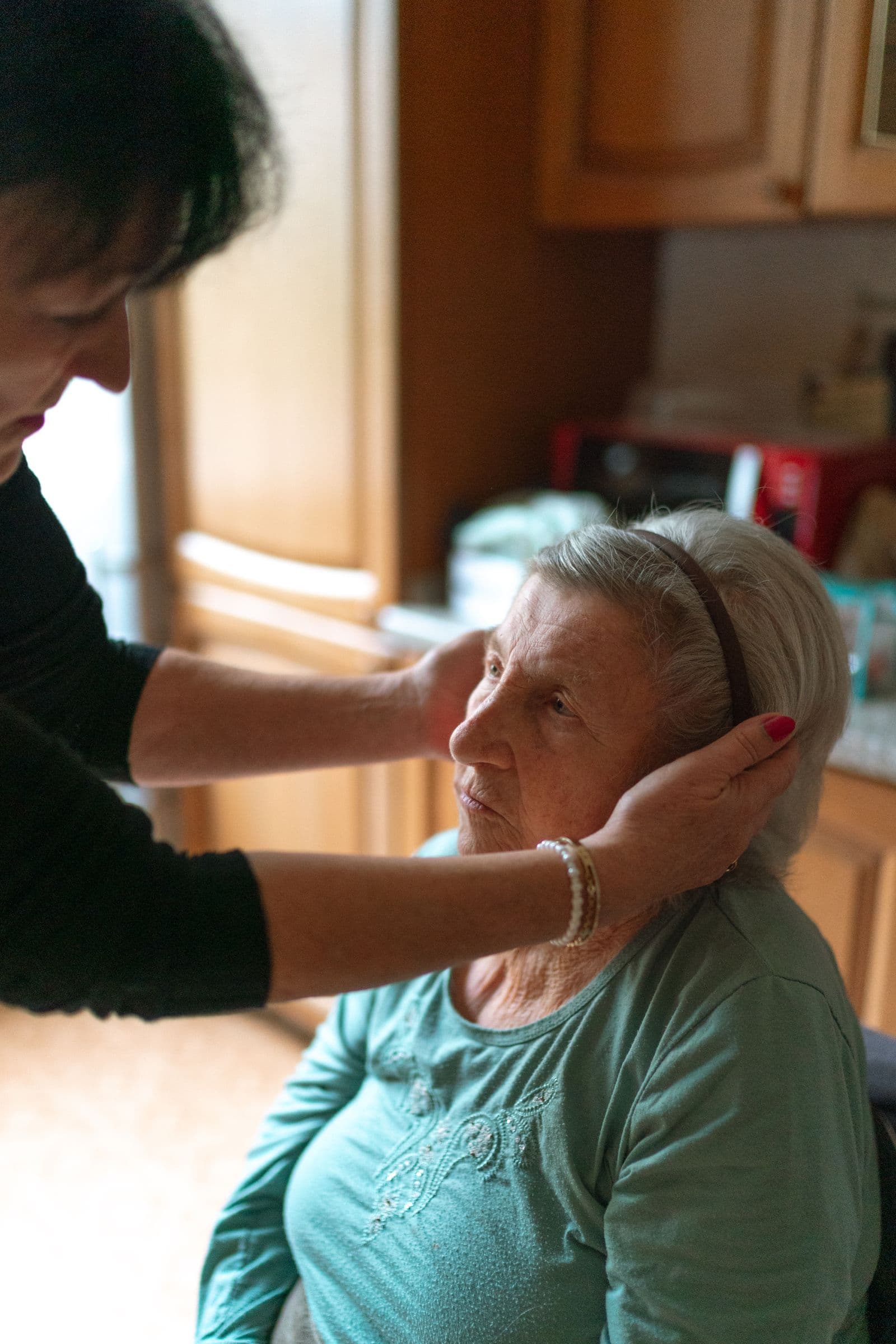 A support worker helping an older woman at home